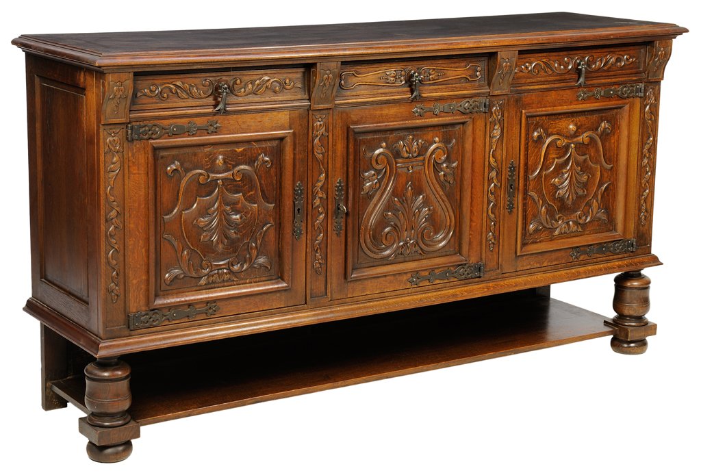 A FRENCH RENAISSANCE REVIVAL SIDEBOARD: A FRENCH RENAISSANCE REVIVAL SIDEBOARD The sideboard having a rectangular parquetry inlaid top above three short drawers and three paneled doors, with carved scrolling leaf decoration, raised on shape