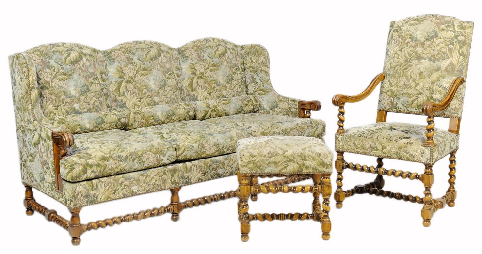 A FRENCH RENAISSANCE REVIVAL SALON SUITE: A FRENCH RENAISSANCE REVIVAL SALON SUITE The suite comprising a settee and a chair with ottoman. Each having a curved crest rail over the upholstered back and seat with nailhead trim, raised on barley