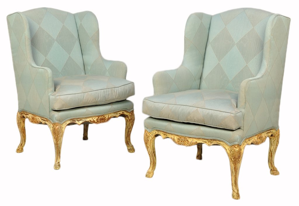 A PAIR OF FRENCH LOUIS XV STYLE PAINTED WINGBACK: A PAIR OF FRENCH LOUIS XV STYLE PAINTED WINGBACK ARMCHAIRS Each chair having a curved crest over the upholstered back and seat within curved arms, raised on a shaped apron centered with a carved shell