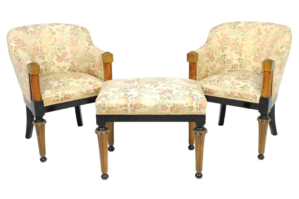 A PAIR OF BIEDERMEIER STYLE ARMCHAIRS AND BENCH: A PAIR OF BIEDERMEIER STYLE ARMCHAIRS AND BENCH The pair of barrel form armchairs with ebonized seat rail and back legs, burled walnut arm rests and cylindrical tapering fore legs. Together with a mat