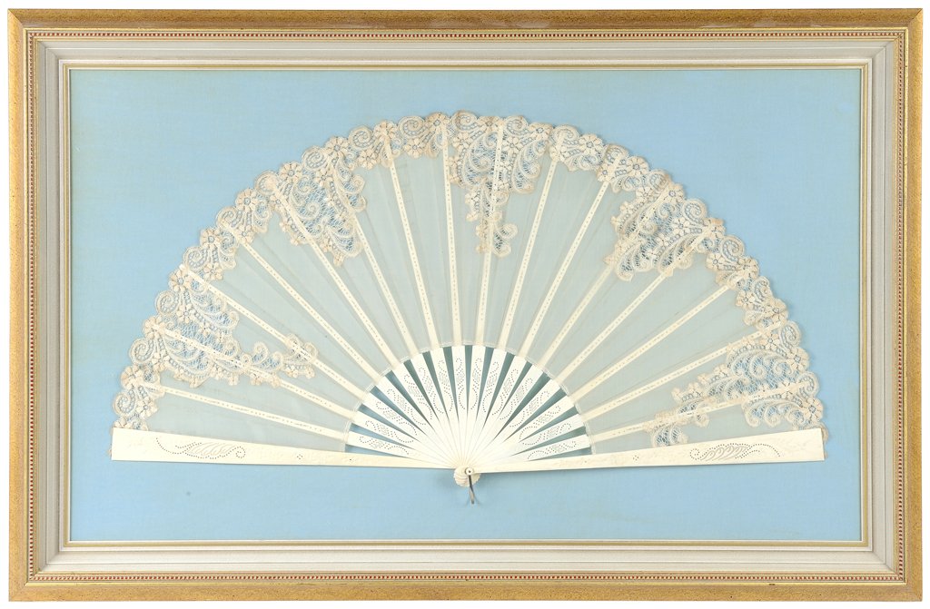 A LADY'S SPANISH LACE FAN IN A SHADOW BOX FRAME: A LADY'S SPANISH LACE FAN IN A SHADOW BOX FRAME The lady's Spanish lace fan with scrolling embroidery to edges, with ivory handle, and presented in a shadow box frame. 8 x 30 inches. Provenance: Prope