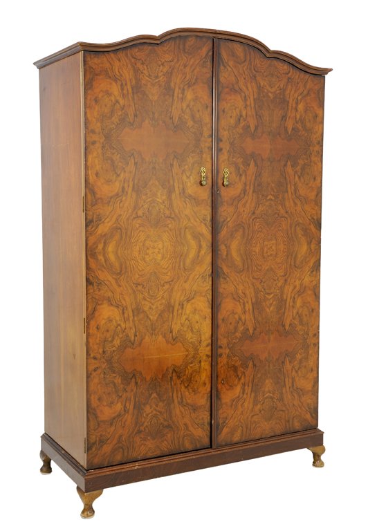 A MAYFAIR CABINET WORKS BURL WALNUT ARMOIRE: A MAYFAIR CABINET WORKS BURL WALNUT ARMOIRE 20th Century Having a shaped pediment over two paneled doors, each fitted with a gilt metal escutcheon and pull, over the stepped plinth, raised on short ca