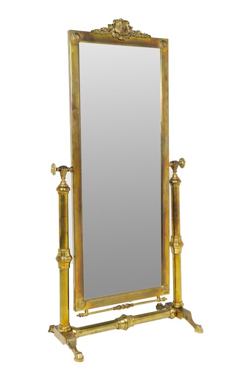 AN AMERICAN GILT METAL CHEVAL MIRROR: AN AMERICAN GILT METAL CHEVAL MIRROR The vertical rectangular mirror plate having a foliate cast crest, suspended from hand form supports, raised on a twin supports joined by a single stretcher. 67 x 