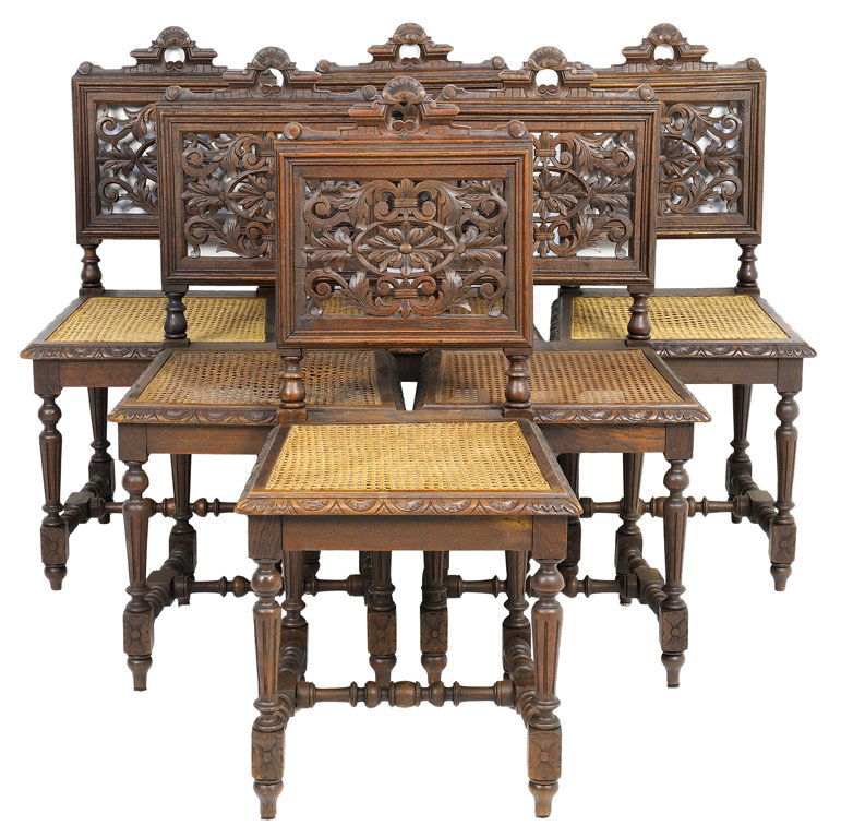 A SET OF SIX RENAISSANCE REVIVAL SIDE CHAIRS: A SET OF SIX RENAISSANCE REVIVAL SIDE CHAIRS Each chair having a domed crest rail over the pierce carved rosette and acanthus leaf back, above the caned seat within an egg and dart border, raised on t