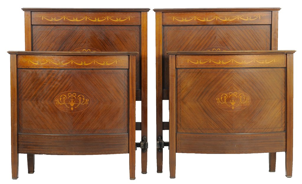 A PAIR OF FRENCH EMPIRE STYLE PARQUETRY BEDS: A PAIR OF FRENCH EMPIRE STYLE PARQUETRY BEDS Each bed having a flared top rail over the swag and foliate marquetry inlaid frieze. The headboard and footboard centered with a ribbon-tied urn within scr