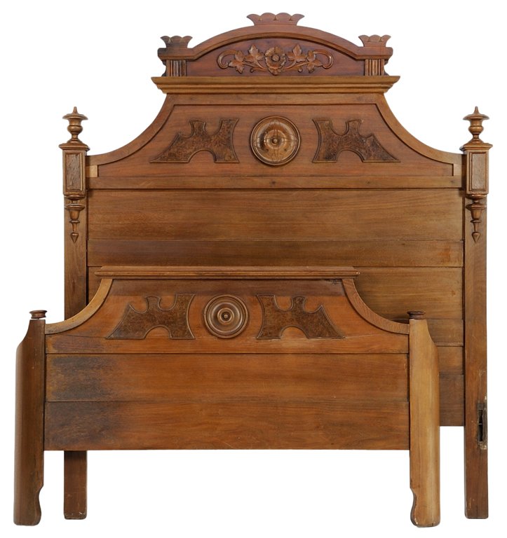 AN EASTLAKE STYLE BED: AN EASTLAKE STYLE BED The bed having a domed top rail over a foliate carved frieze, raised on twin supports with urn form finials, ending in square feet. Comprising headboard, footboard and side rails
