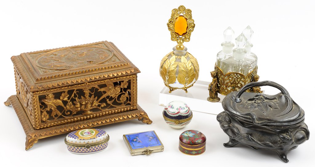 AN ASSEMBLED GROUP OF LADY'S VANITY ARTICLES: AN ASSEMBLED GROUP OF LADY'S VANITY ARTICLES The eight-piece group comprising two diminutive Limoges box, a gilt-metal footed box with scrolled foliate openwork sides, an Art Nouveau silver-plate foot