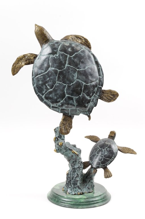 A PATINATED METAL SEA TURTLE SCULPTURE: A PATINATED METAL SEA TURTLE SCULPTURE The sculpture of patinated metal with heavy verdigris depicting two sea turtles in upward motion fixed to a rockery base and further raised on a stepped marbleiz