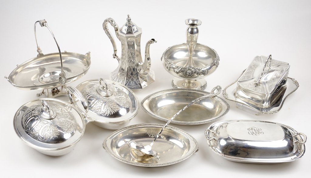 AN ASSEMBLED GROUP OF SILVER-PLATE ARTICLES 8 pieces: AN ASSEMBLED GROUP OF SILVER-PLATE ARTICLES The group comprising a single-horn epergne center bowl with chased floral motif and rubbed mark to base, a covered cheese dish with marks for William Hutton