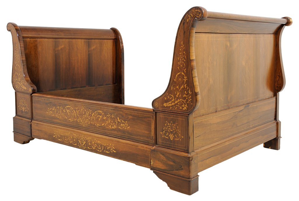 A VARIOUS WOODS MARQUETRY SLEIGH BED: A VARIOUS WOODS MARQUETRY SLEIGH BED The headboard and footboard each having an everted top rail, with inlaid marquetry design to the sides, raised on bracket feet. Comprising heaboard, footboard and 