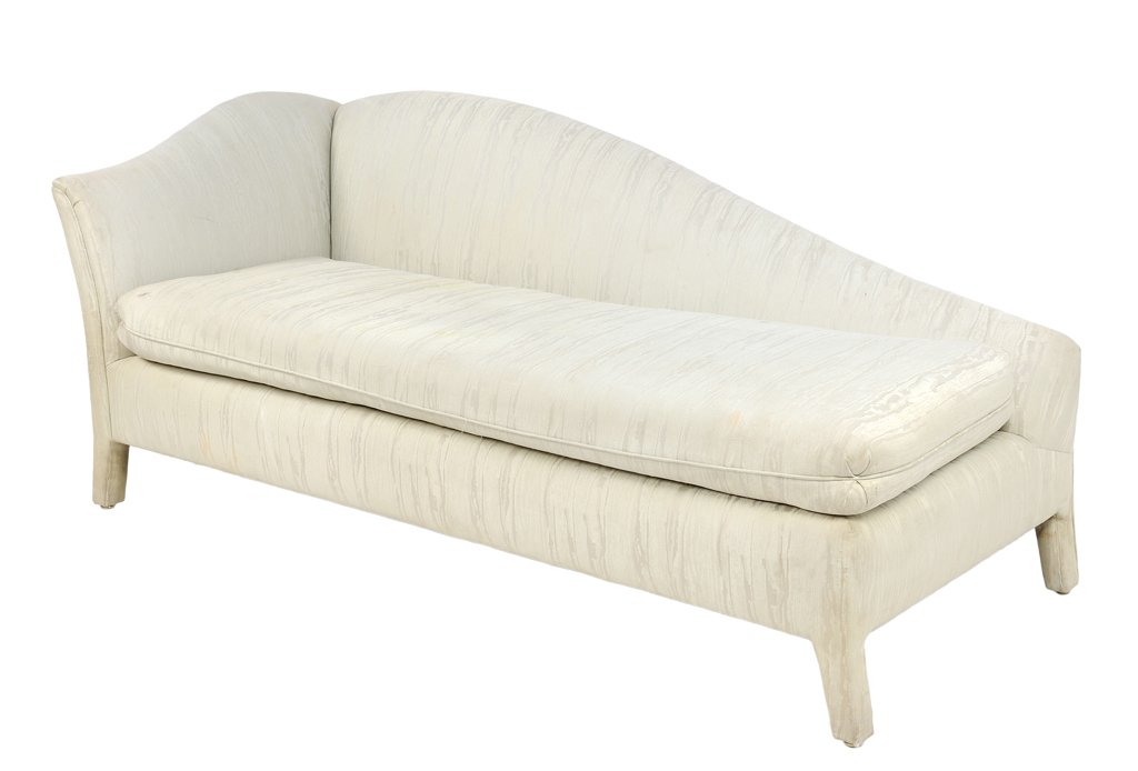 A WINGBACK UPHOLSTERED CHAISE LOUNGE: A WINGBACK UPHOLSTERED CHAISE LOUNGE The chaise lounge with a curved top rail over the upholstered body, raised on slightly splayed legs. H 32 x W 75 x D 34 inches.