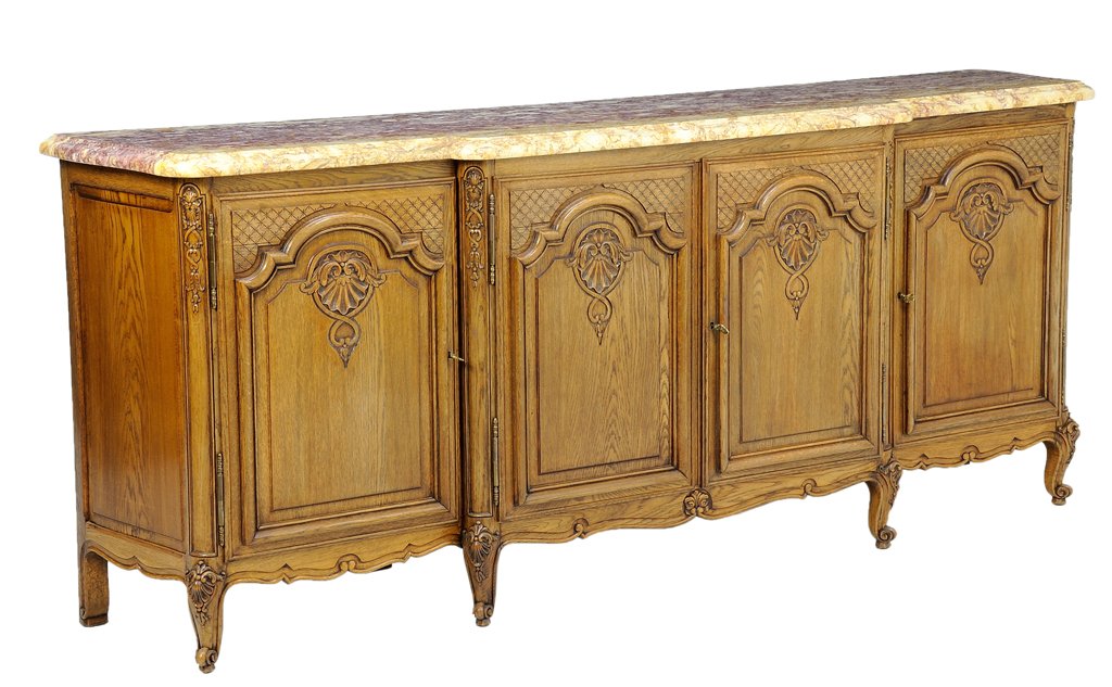 A FRENCH LOUIS XV STYLE OAK SIDEBOARD: A FRENCH LOUIS XV STYLE OAK SIDEBOARD The sideboard having a marble rectangular stepback top over four paneled doors, each carved with lattice and shell decoration, coffer paneled sides, shaped apron,