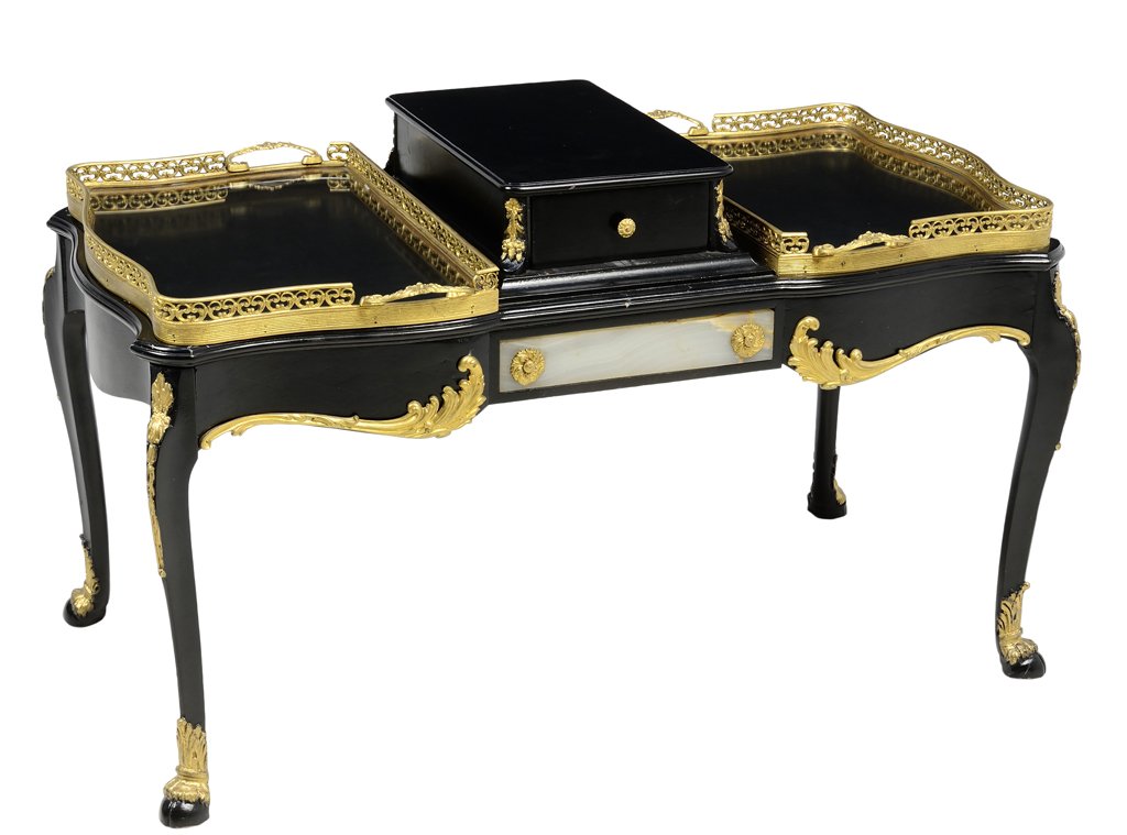 A FRENCH EMPIRE STYLE EBONIZED GILT METAL MOUNTED LOW: A FRENCH EMPIRE STYLE EBONIZED GILT METAL MOUNTED LOW TABLE The table having a rectangular top with two galleried ends centered with a single drawer, over the shaped apron, the whole raised on cabriol