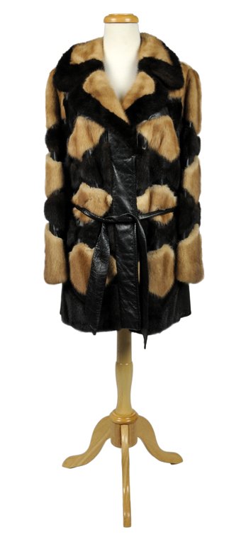 A CONTEMPORARY MINK FUR JACKET: A CONTEMPORARY MINK FUR JACKET A contemporary two tone mink fur jacket with leather inserts. Lined, clasp closure with a notched collar. Yoke 16" Sleeve 24"