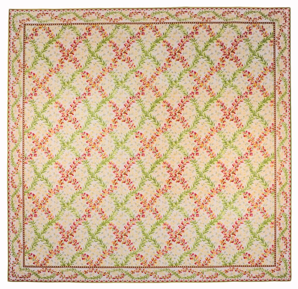 A STARK FLORAL RUG: A STARK FLORAL RUG USA, 20th Century The rug having a floral lattice work design on an ivory ground within scrolling foliate border. 12ft x 12ft