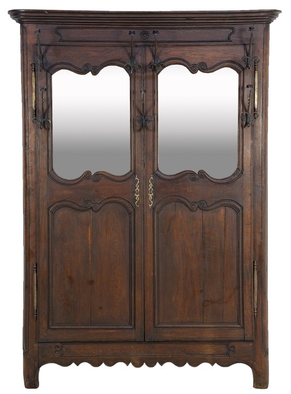 A FRENCH PROVINCIAL STYLE HALL TREE: A FRENCH PROVINCIAL STYLE HALL TREE The hall tree having a flared cornice over a plain frieze fitted with two cartouche form mirror plates surrounded by a series of hooks, above coffer panels, undulat
