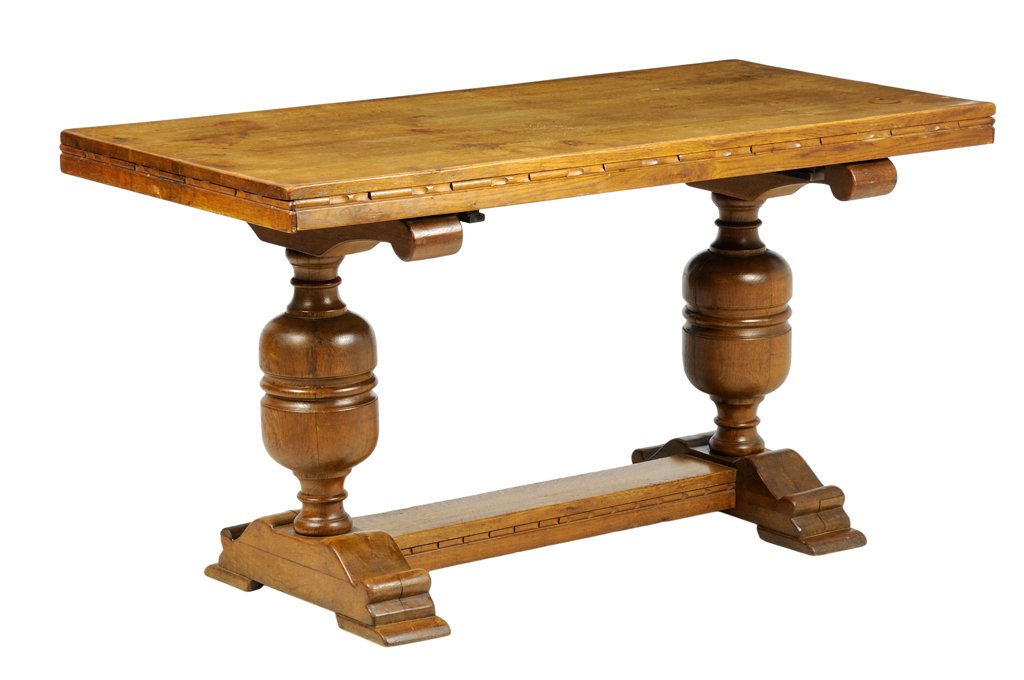 A SPANISH STYLE OAK FLIP-TOP DINING TABLE: A SPANISH STYLE OAK FLIP-TOP DINING TABLE The dining table having a rectangular flip-top, raised on baluster form legs, raised on twin bracket supports, joined by a single stretcher. H 30½ x W 55½ x