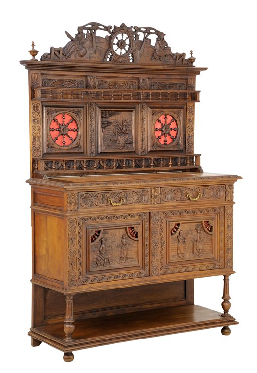 A FRENCH BRITTANY STYLE SIDEBOARD: A FRENCH BRITTANY STYLE SIDEBOARD The sideboard having a flared pediment over the carved wheel crest flanked by opposing peasants in a landscape, over the rosette carved frieze, and central panel carv