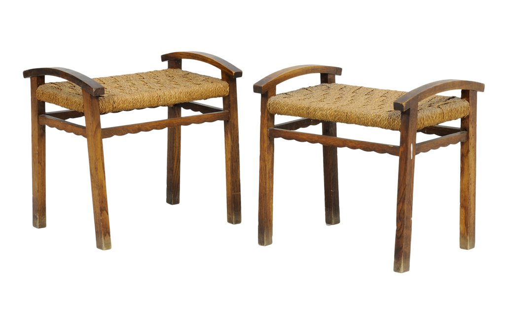 A PAIR OF ARTS AND CRAFTS STYLE STOOLS: A PAIR OF ARTS AND CRAFTS STYLE STOOLS Early 20th Century Each stool having a woven seat, raised on block legs, joined by stretchers. H 19¼ x W 20 x D 14¾ inches.