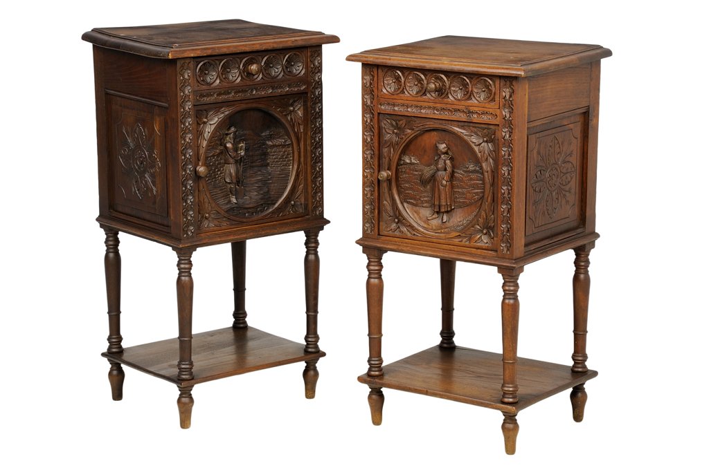 A PAIR OF FRENCH BRITTANY STYLE BEDSIDE CABINETS: A PAIR OF FRENCH BRITTANY STYLE BEDSIDE CABINETS Each bedside cabinet having a rectangular top over the conforming case, over a single rosette carved drawer and a paneled door, carved with a scene of 
