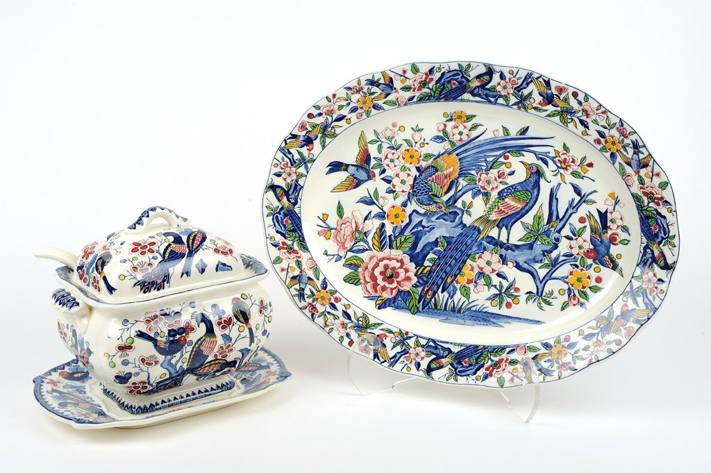 TWO IMARI PATTERN IRONSTONE SERVING ARTICLES: TWO IMARI PATTERN IRONSTONE SERVING ARTICLES Comprising a lidded tureen and underplate with accompanying ladle, and an oval serving platter, each in an Imari pattern with birds and blossoms motif thro