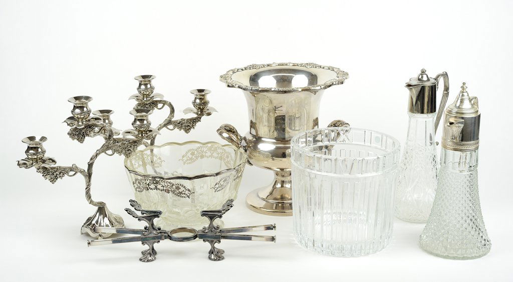 AN ASSEMBLED GROUP OF TABLEWARE 8 pieces total: AN ASSEMBLED GROUP OF TABLEWARE Comprising a Tiffany & Co. crystal ice bucket, a pair of silver-plate 3-light candelabra in a grapes-and-leaves motif, a Towle silver-plate wine cooler, a glass punch b