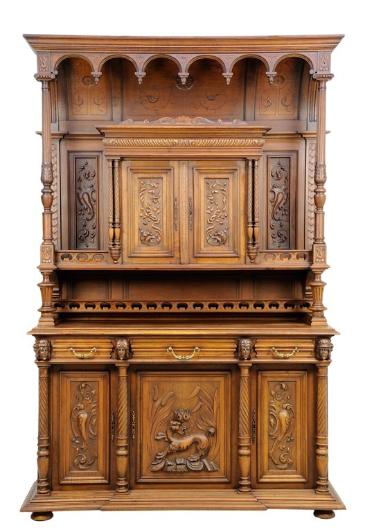 A RENAISSANCE REVIVAL BUFFET A DEUX CORPS: A RENAISSANCE REVIVAL BUFFET A DEUX CORPS The buffet a deux corps having a flared cornice, over the pendant vaulted frieze, above a pair of paneled doors, flanked by double columns, the whole raised o