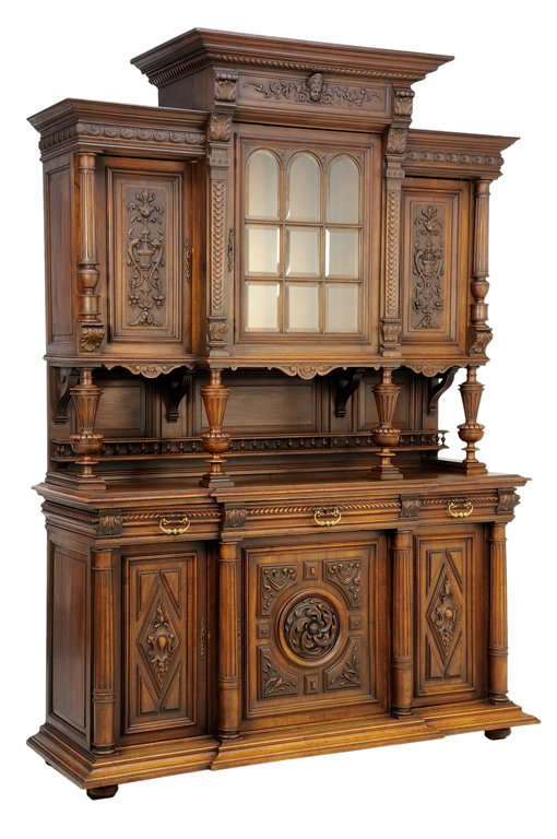 A RENAISSANCE REVIVAL WALNUT BUFFET A DEUX CORPS: A RENAISSANCE REVIVAL WALNUT BUFFET A DEUX CORPS The buffet a deux corps having a stepped flared cornice over the mask and foliate carved frieze, above a central glazed astragal inset door flanked by 