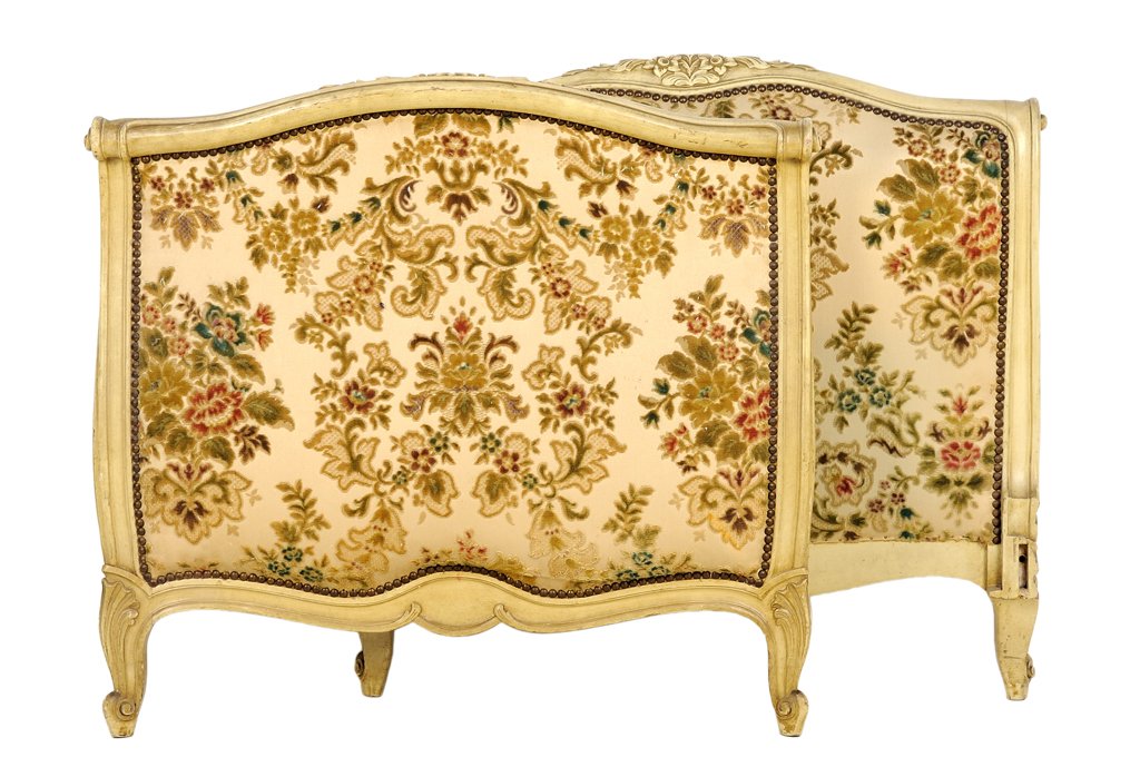 A FRENCH PROVINCIAL STYLE PAINTED AND UPHOLSTERED BED: A FRENCH PROVINCIAL STYLE PAINTED AND UPHOLSTERED BED The bed having a curved top rail over the upholstered back panel with nailhead border, over the shaped apron, raised on short cabriole legs ending