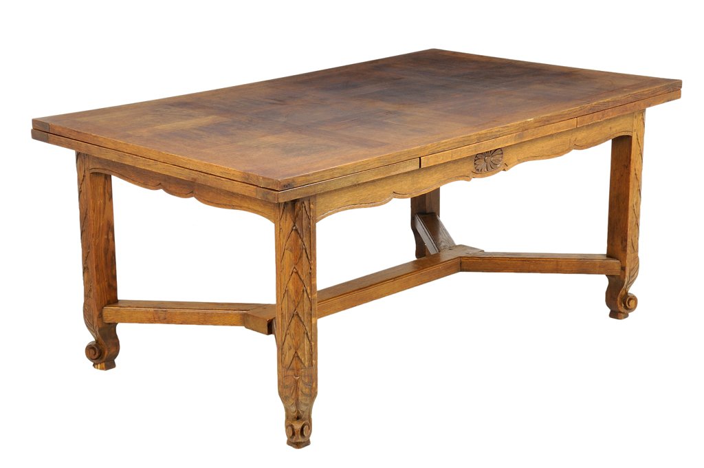 A FRENCH PROVINCIAL STYLE EXTENSION DINING TABLE: A FRENCH PROVINCIAL STYLE EXTENSION DINING TABLE The table having a rectangular parquetry inlaid top over two leaves, above the shaped apron, with carved rosette decoration, raised on square legs, joi