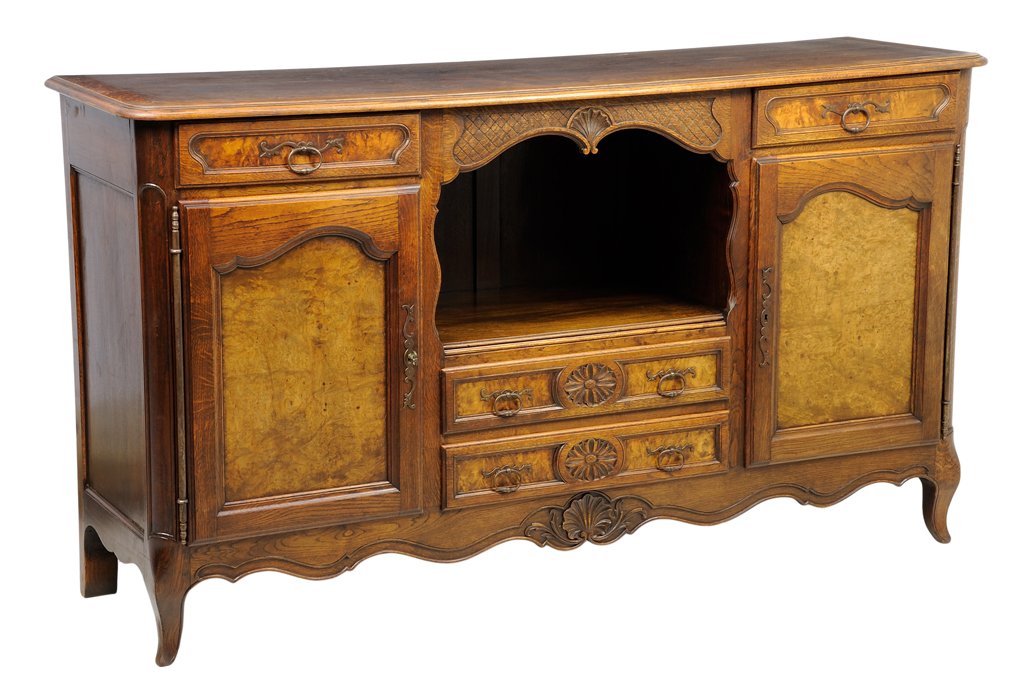 A FRENCH LOUIS XV STYLE OAK AND BURLWOOD SIDEBOARD: A FRENCH LOUIS XV STYLE OAK AND BURLWOOD SIDEBOARD The sideboard having a rectangular top with rounded corners over two short drawers and two paneled doors, centered with two long drawers, above the s