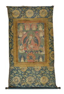 A TIBETAN THANGKA SCROLL: A TIBETAN THANGKA SCROLL Qing Dynasty Of rectangular form, the pigment on cotton thangka depicting the Buddha surrounded by various Lama and Arhats, above a depiction of Mahakala, flanked to each side