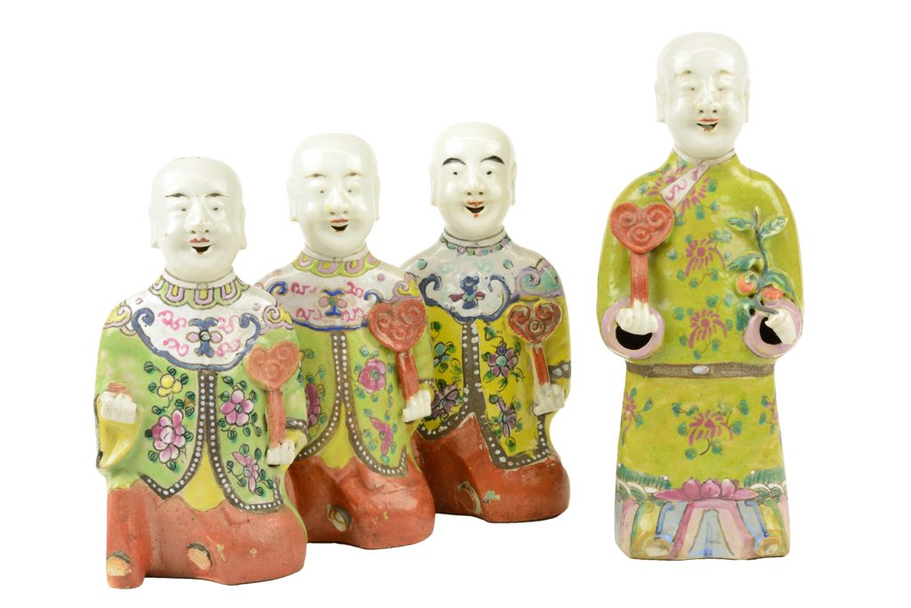 FOUR CHINESE FAMILLE ROSE FIGURES: FOUR CHINESE FAMILLE ROSE FIGURES Early Qing Dynasty Comprising three kneeling figures, each with Ruyi-form scepters, together with a standing figure of conforming style. H 8½ x W 9½ x D 2¼ inches.