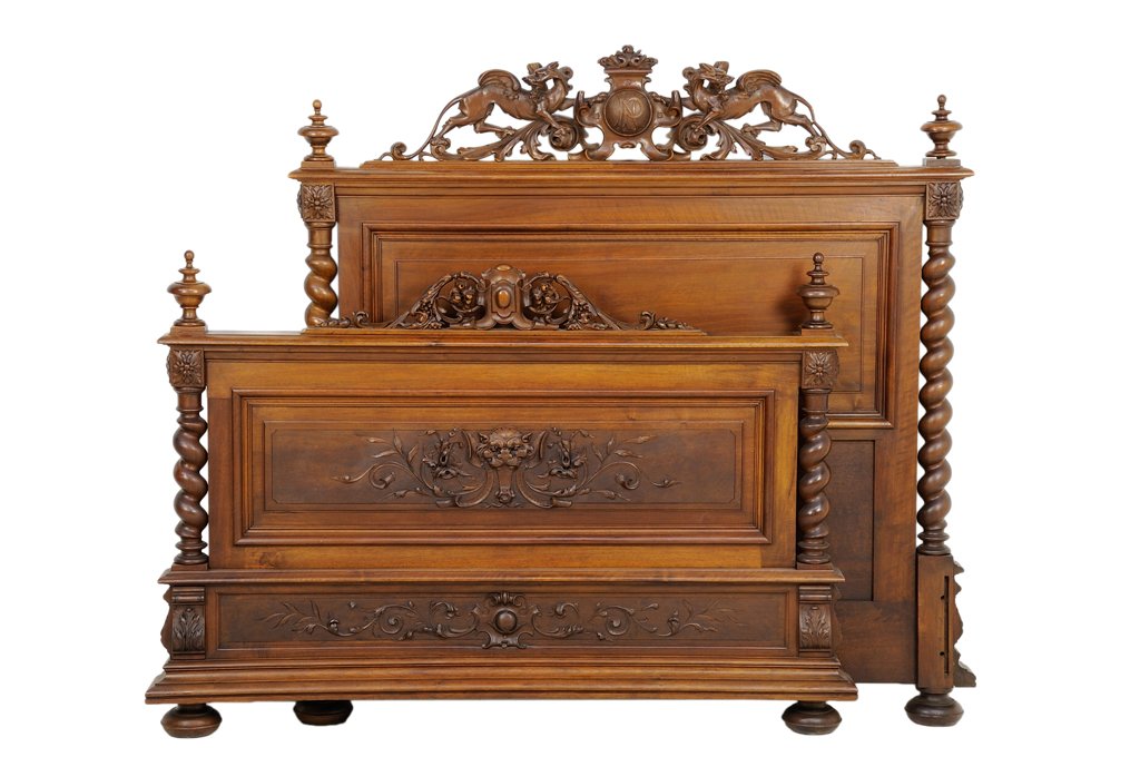 A FRENCH RENAISSANCE REVIVAL BED: A FRENCH RENAISSANCE REVIVAL BED The headboard having a straight top rail beneath the crest carved with a monogrammed shield flanked by scrolling foliage and opposing griffins, the plain paneled back 