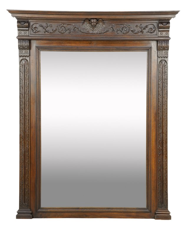 A FRENCH RENAISSANCE REVIVAL MIRROR: A FRENCH RENAISSANCE REVIVAL MIRROR With a straight flared cornice surmounting the frieze carved with scrolling foliate decoration and centered with the mask of a putto, above the vertical mirror plat