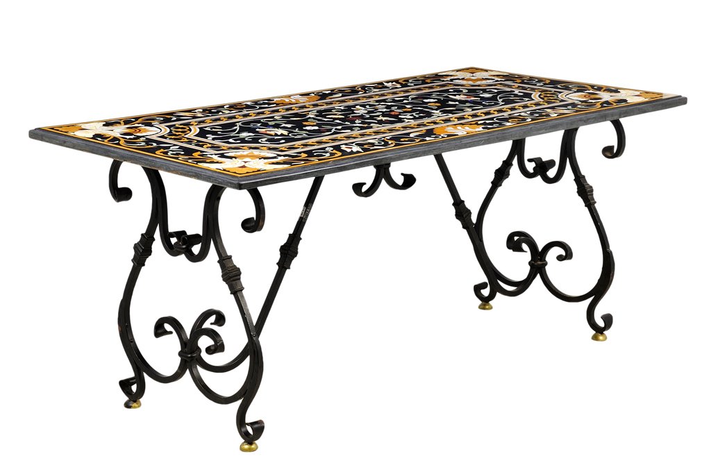 AN ITALIAN PIETRA DURA DINING TABLE: AN ITALIAN PIETRA DURA DINING TABLE The dining table having scrolling foliate inlay with opposing fish at each corner, raised on a hand-forged wrought iron base. H 13¼ x W 59 x D 24 inches.