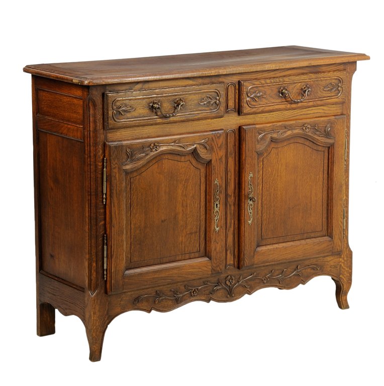 A FRENCH PROVINCIAL STYLE SIDEBOARD: A FRENCH PROVINCIAL STYLE SIDEBOARD The rectangular top with rounded corners, over two short drawers with bail handles, above a pair of paneled doors, each with a vertical foliate escutcheon, over the