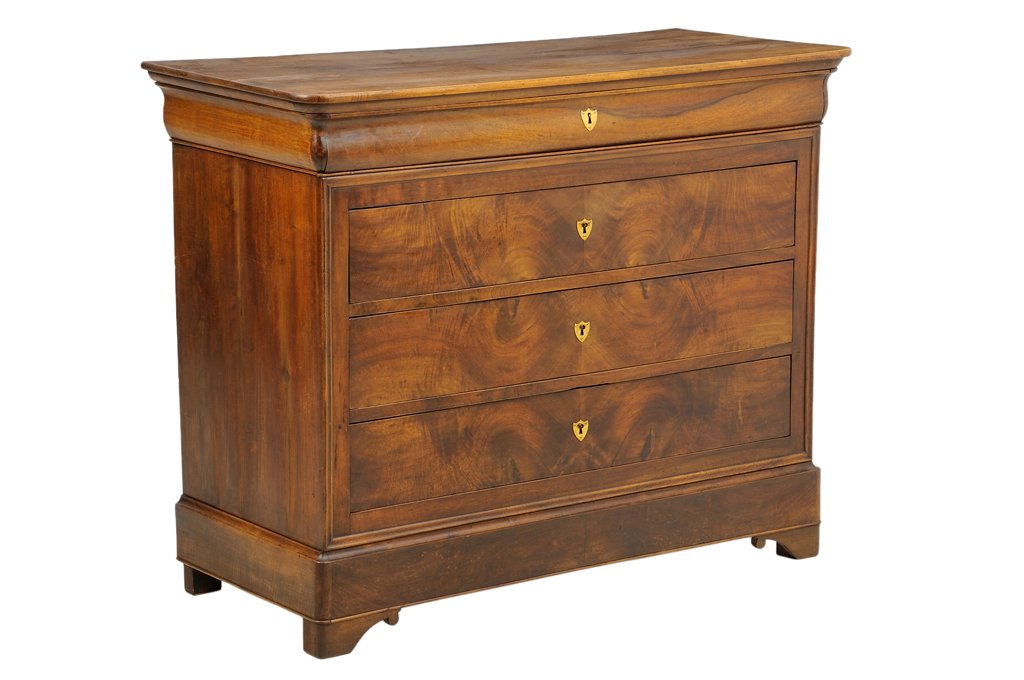 A FRENCH LOUIS PHILIPPE STYLE WALNUT CHEST OF DRAWERS: A FRENCH LOUIS PHILIPPE STYLE WALNUT CHEST OF DRAWERS With a rectangular top over the conforming case, fitted with three long drawers with shield plate escutcheons, raised on a plinth base ending in s
