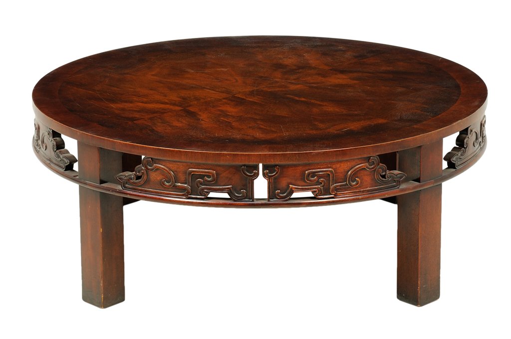 A CHINESE STYLE CARVED HARDWOOD LOW TABLE: A CHINESE STYLE CARVED HARDWOOD LOW TABLE The low table having a circular top over the pierce carved apron, raised on block legs. H 15½ x diam 40½ inches.