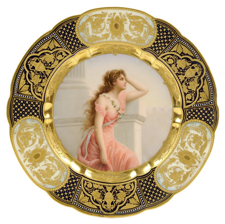 A ROYAL VIENNA CABINET PLATE, YEARNING, SIGNED WAGNER: A ROYAL VIENNA CABINET PLATE, YEARNING, SIGNED WAGNER Late 19th century The hand painted central medallion depicting a maiden wearing a pink dress, a garland of white flowers across one shoulder and s