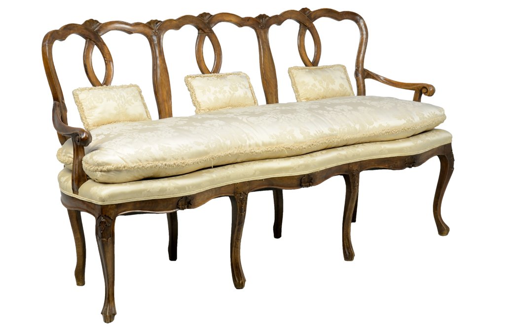 A FRENCH LOUIS XV STYLE TRIPLE-BACK UPHOLSTERED SETTEE: A FRENCH LOUIS XV STYLE TRIPLE-BACK UPHOLSTERED SETTEE The settee having a curved crest rail over the twisted back splats, above the upholstered stuff-over seat, within open scrolled arms, over the sh