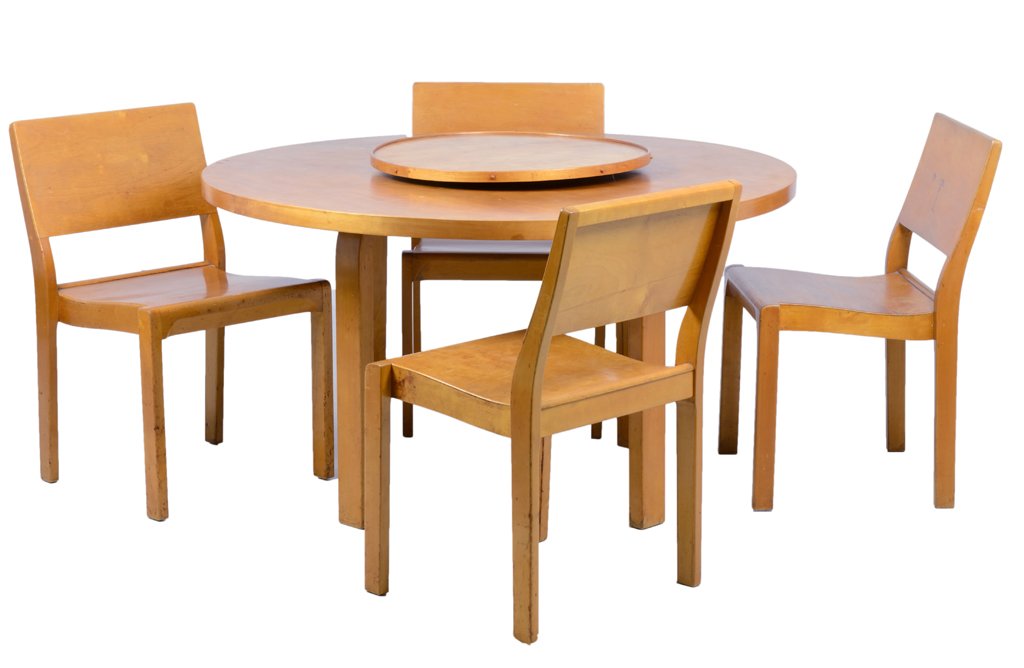 AN ALVAR AALTO BIRCH DINING SET: AN ALVAR AALTO BIRCH DINING SET The table with a circular top, raised on square legs, surmounted with a lazy susan. Together with four dining chairs. Stamped Aalto Design, Made in Finland. With Finmar