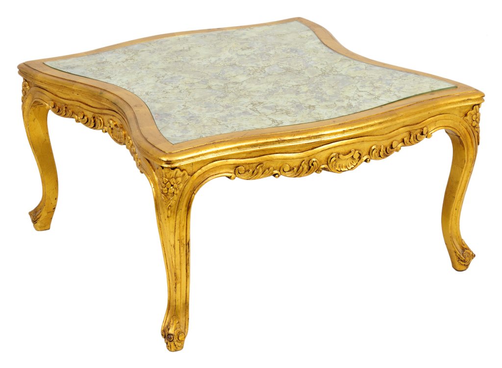 A FRENCH LOUIS XV STYLE GILTWOOD LOW TABLE: A FRENCH LOUIS XV STYLE GILTWOOD LOW TABLE The low table having a rectangular shaped top with an eglomise inset surface, above the shell and foliate carved apron, raised on cabriole legs, ending in sc
