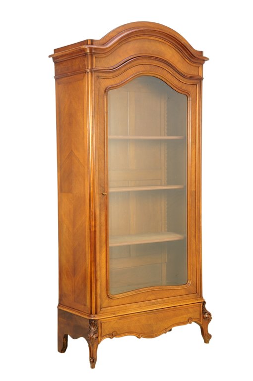A FRENCH LOUIS XV STYLE VITRINE CABINET: A FRENCH LOUIS XV STYLE VITRINE CABINET A single shaped glazed door surmounted by a domed pediment and flared cornice, above a shaped skirt, raised on short cabriole fore legs, with carved acanthus kn