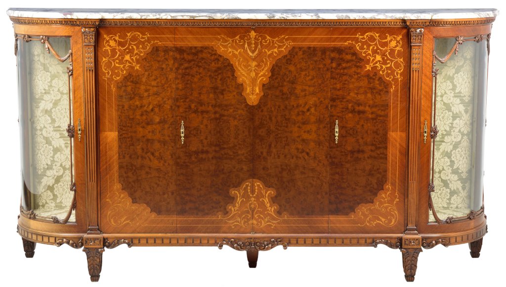 A CONTINENTAL BURLWOOD AND MARQUETRY SIDEBOARD: A CONTINENTAL BURLWOOD AND MARQUETRY SIDEBOARD The sideboard having a demilune form marble top surmounting the conforming case, fitted with paneled doors, within a scrolling marquetry border, flanked 