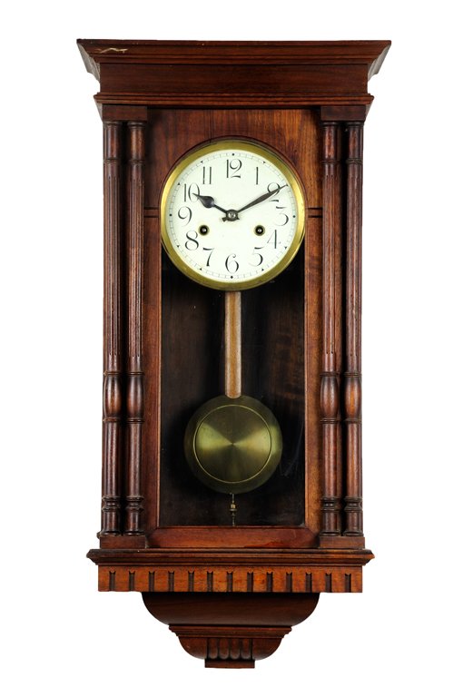 A FRENCH WALNUT WALL CLOCK: A FRENCH WALNUT WALL CLOCK Having a stepped pediment above the conforming case, the glass door over the circular enameled dial with painted Arabic hours suspending the pendulum, above the tapered base