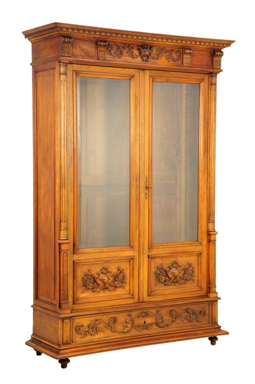 A FRENCH RENAISSANCE REVIVAL VITRINE CABINET: A FRENCH RENAISSANCE REVIVAL VITRINE CABINET The flared cornice above a single band of dentil molding, over a shield and foliate carved frieze flanked by a pair of carved cornices, above the glazed an