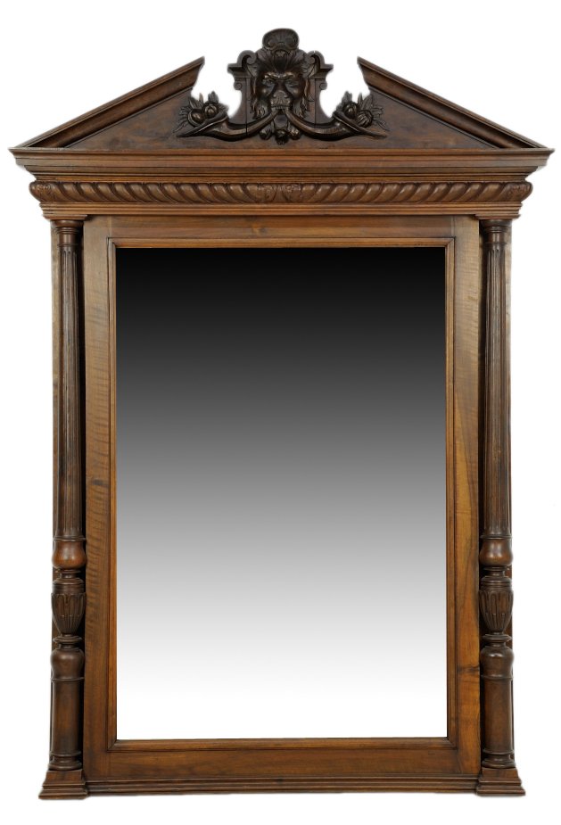A RENAISSANCE REVIVAL PIER MIRROR: A RENAISSANCE REVIVAL PIER MIRROR The pier mirror having a broken arch pediment centered with a carved lion mask and opposing cornucopia, over the vertical rectangular mirror plate, flanked by fluted 