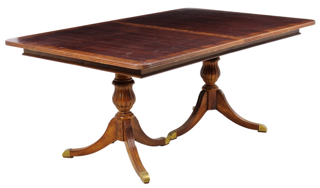 AN ENGLISH REGENCY STYLE DINING TABLE: AN ENGLISH REGENCY STYLE DINING TABLE The dining table having a rectangular top with two leaves, with banding inlay, raised on twin baluster form supports, raised on quadripartite reeded bases, ending