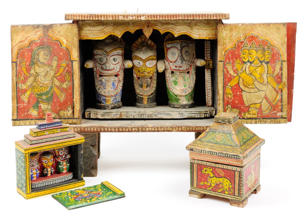THREE INDO-TIBETAN PAINTED AND CARVED WOOD DEVOTIONAL: THREE INDO-TIBETAN PAINTED AND CARVED WOOD DEVOTIONAL ARTICLES Comprising a carved and painted wood shrine or traveling altar housing three figures, together with an additional, diminutive example, an